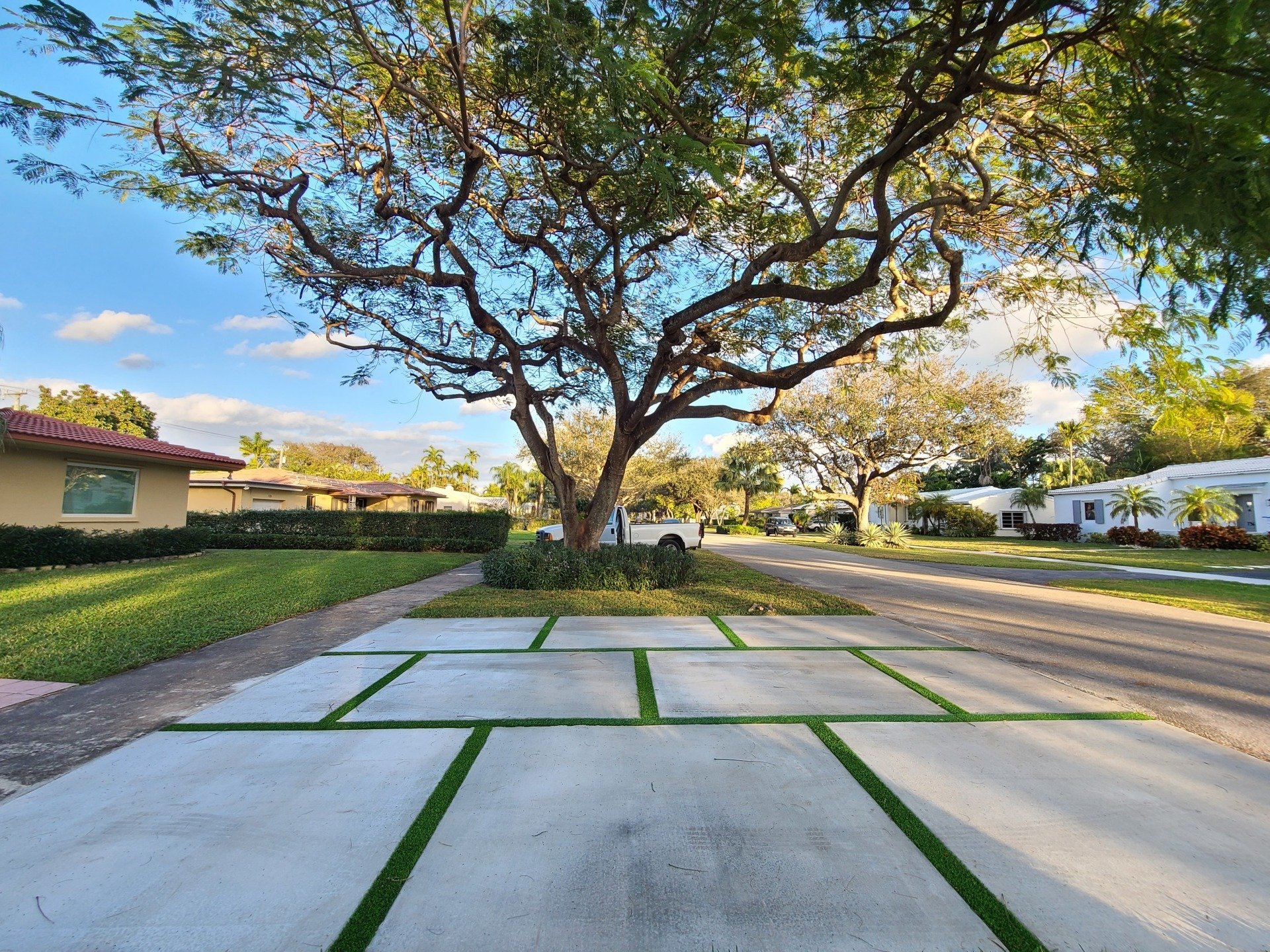 Upscale home exterior with concrete slabs and artifficial grass padding